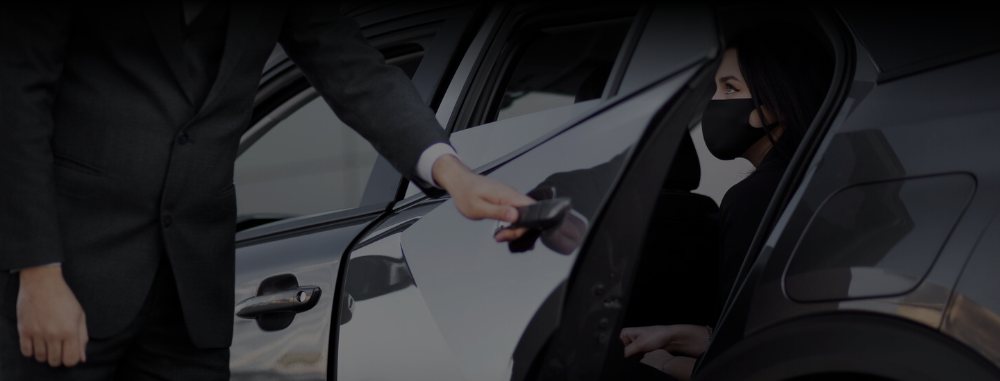 Chauffeur opening the door for a passenger